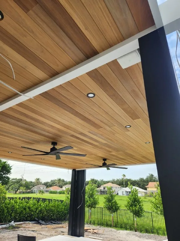 White wireless access point mounted beneath a wood pergola ceiling